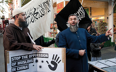njem Choudary delivers a speech as Muslims and Islamists protest in London’s China Town