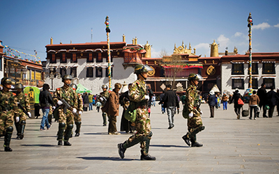 Chinese army soldiers patrol the Barkhor Square in front of Jokhang Temple