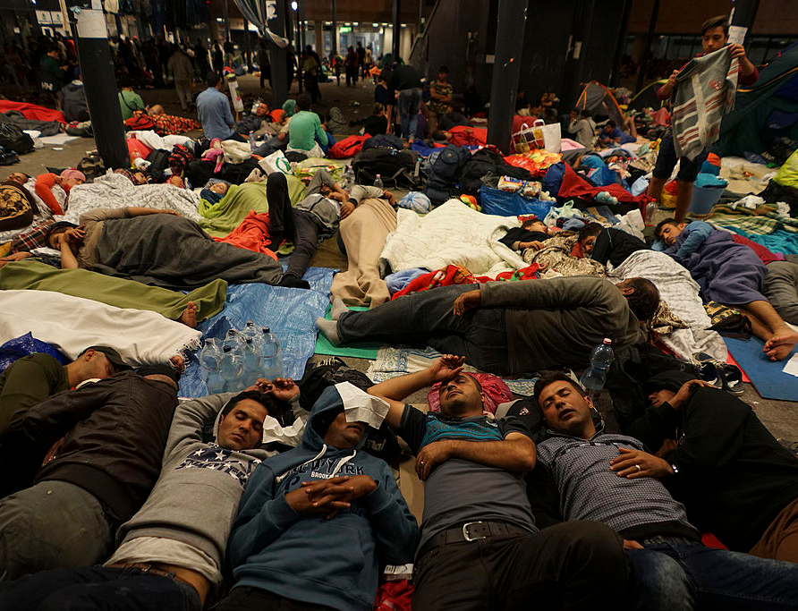 Syrian refugees having rest at the floor of Keleti railway station. Refugee crisis. Budapest, Hungary, Central Europe