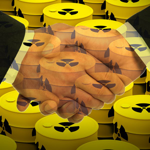 Handschlag vor Atommüll-Fässern