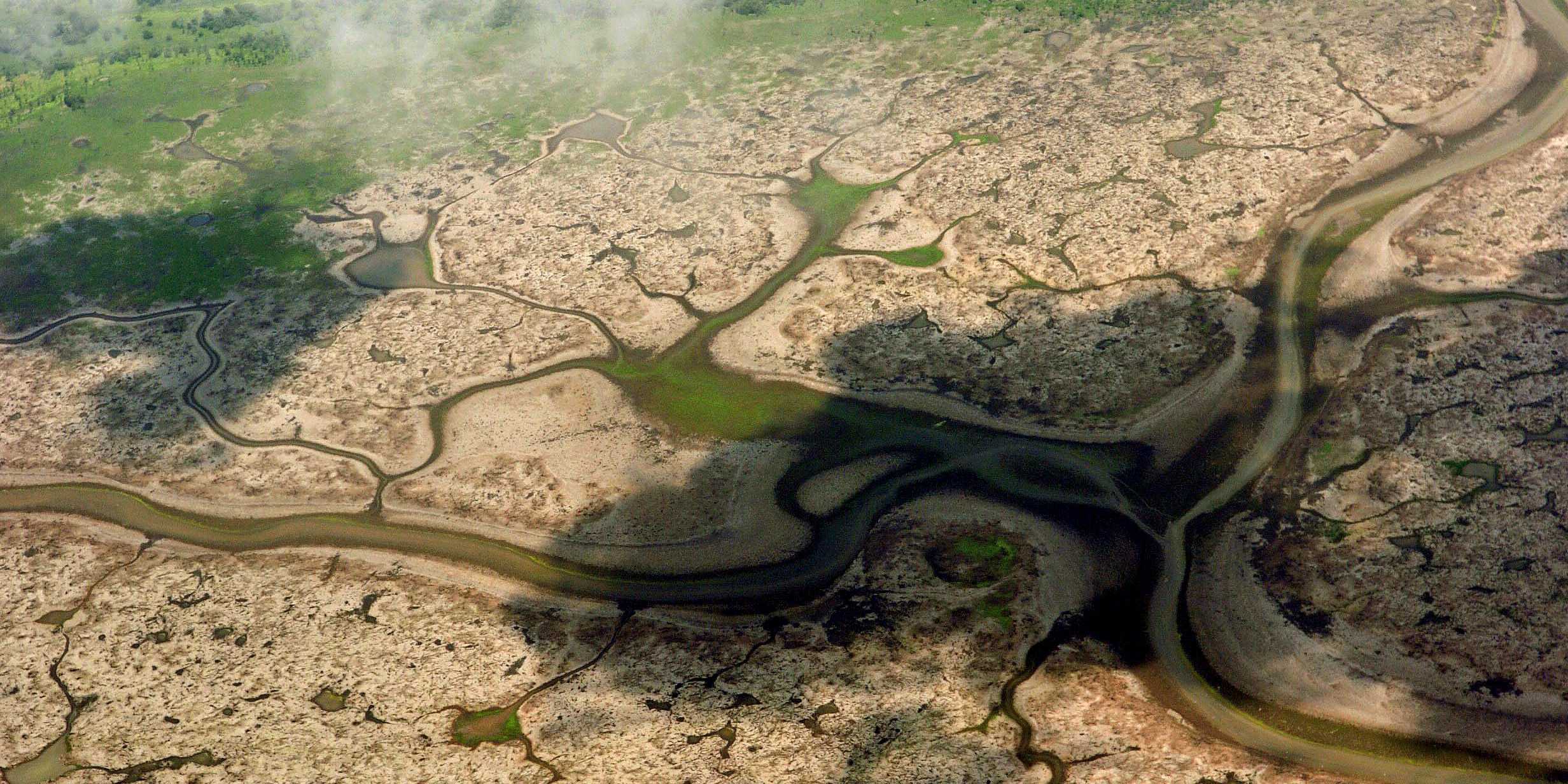 Lauftaufnahme des Anama-Sees. Der Boden ist so ausgetrocknet, dass es Risse im Boden hat. 