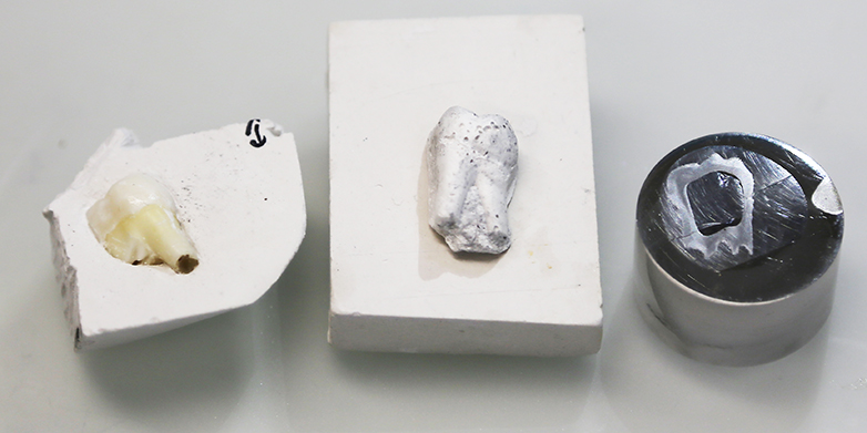 The left structure is showing the natural tooth in its gypsum mold, the middle structure is the artificial tooth (sintered but not yet polymer infiltrated). The model on the right has been sintered and polymer infiltrated. It is embedded in a "puck" to enable polishing and coated with Platinum to prevent charging in the electron microscope. Image: Tobias Niebel/ETH Zurich