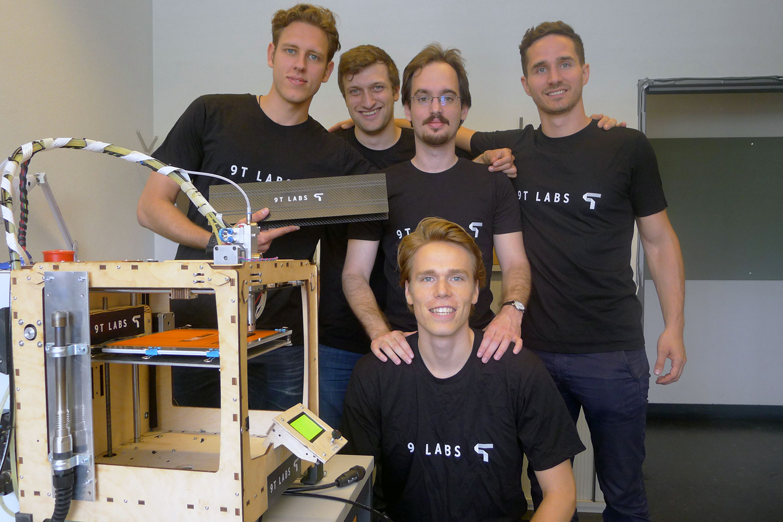 Enlarged view: Part of 9T Labs team (left to right): Giovanni Cavolina, Filippo Kusch, Selçuk Ercan, Martin Eichenhofer, Chester Houwink next to the prototype 3D printer. (Photograph: Courtesy of 9T Labs)