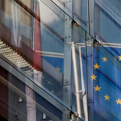 Swiss and European flag reflected in office building