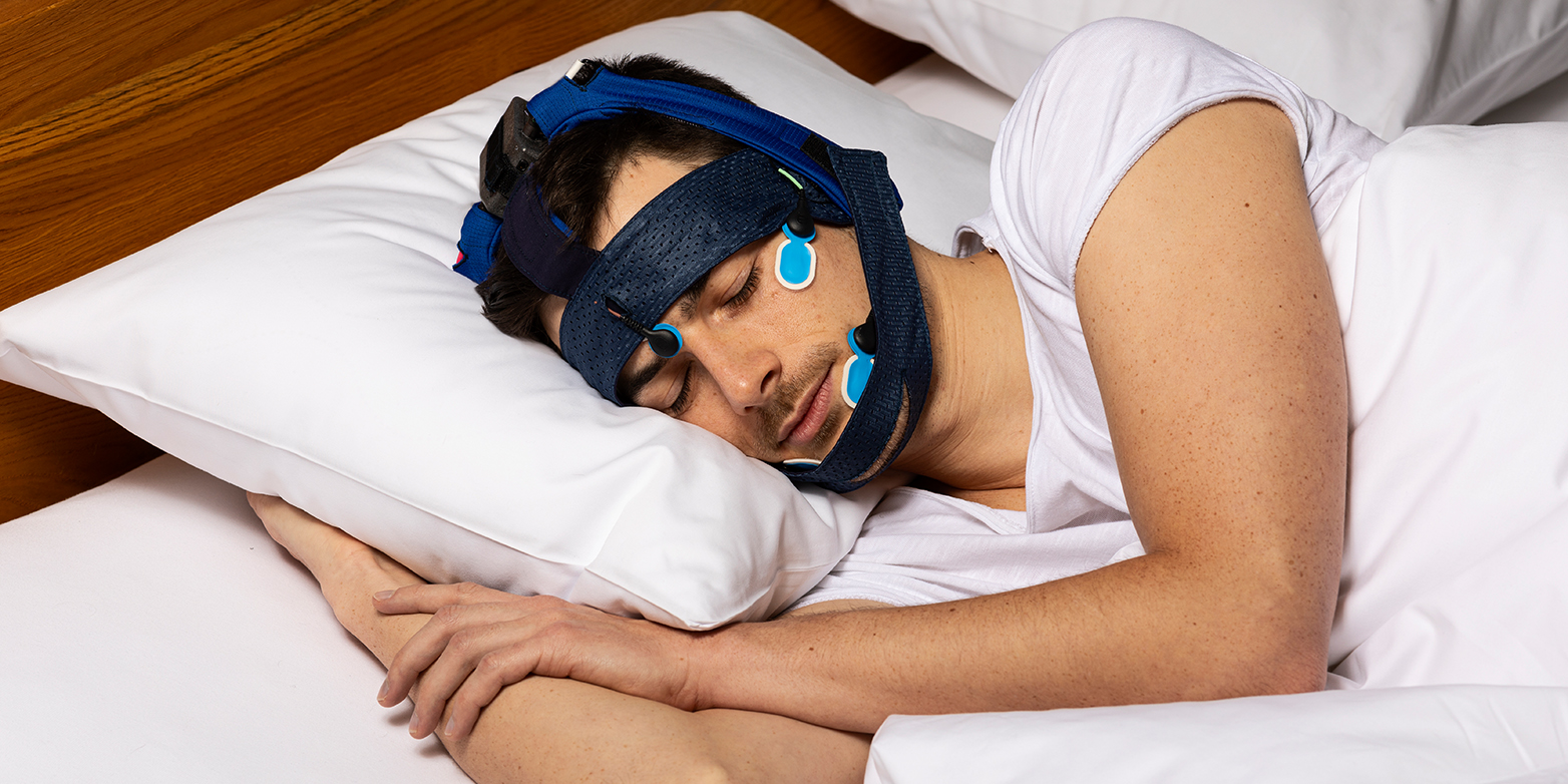 Sleeping person wearing a system developed by SleepLoop.