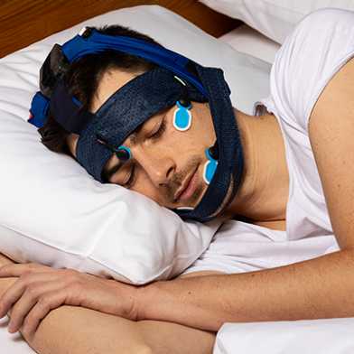 Sleeping person wearing a system developed by SleepLoop.