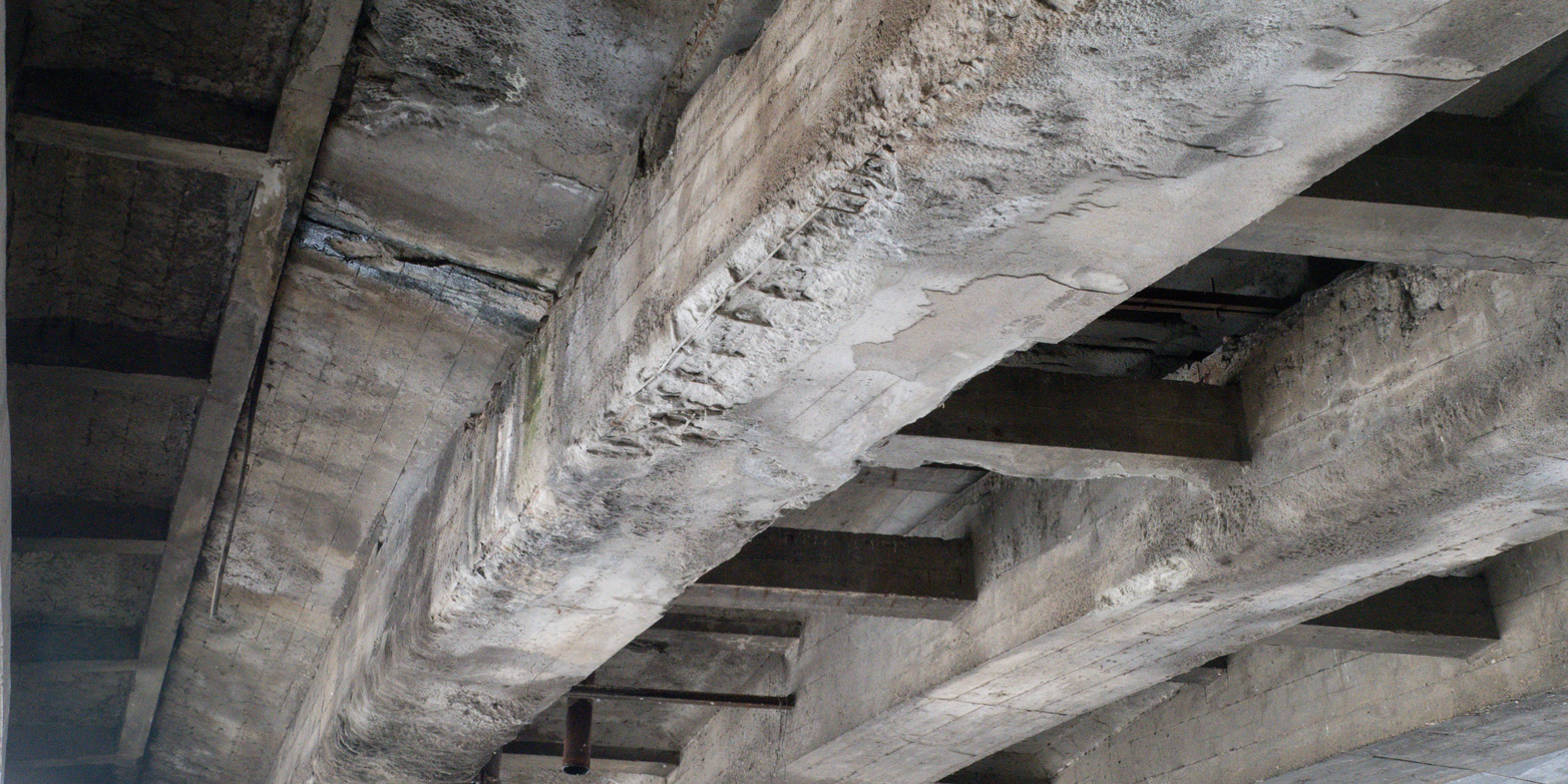 The deteriorated substructure of a steel-reinforced concrete bridge