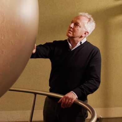 Domenico Giardini looks at a Mars globe