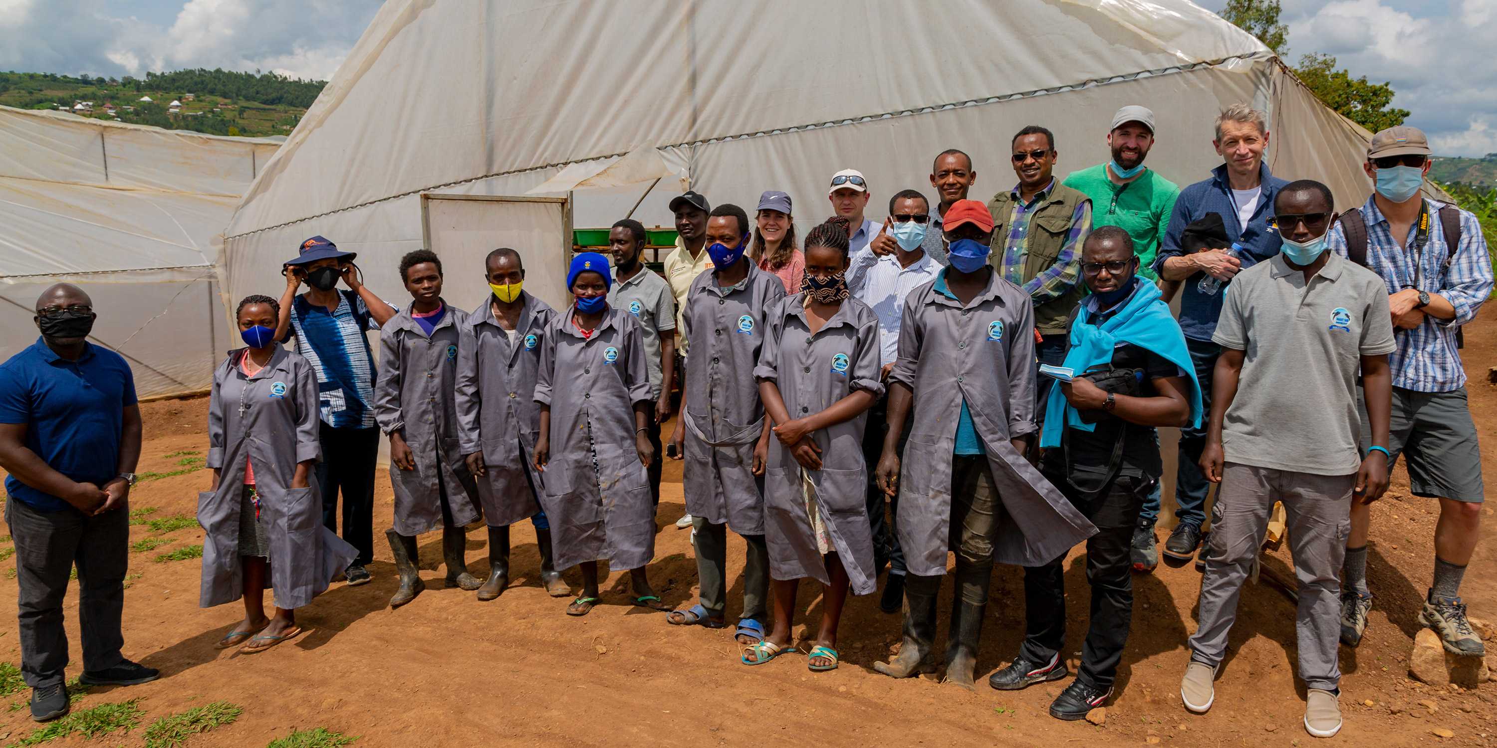 Group photo Runres team in Rwanda in front of a white tent