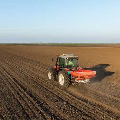 Tractor drives over farmland