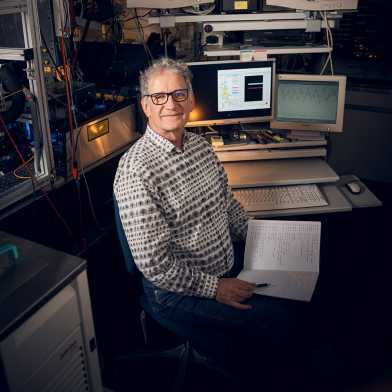 Tom Peter in his lab, surrounded by monitors and measuring devices