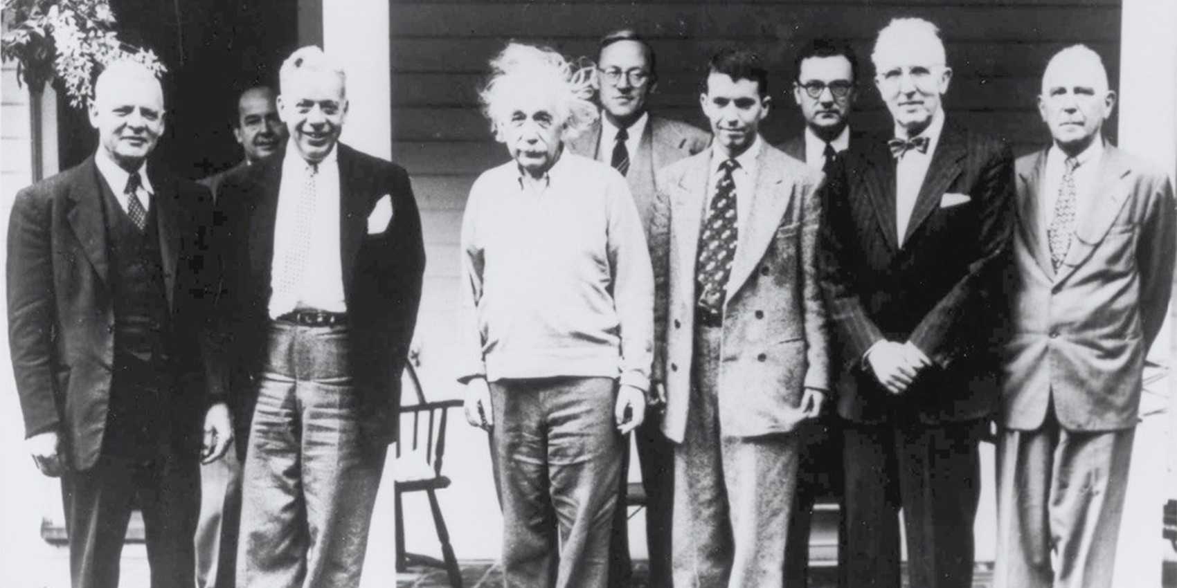 Old black and white photo of a group of men, including Albert Einstein and John von Neumann.
