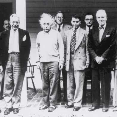 Old black and white photo of a group of men, including Albert Einstein and John von Neumann.