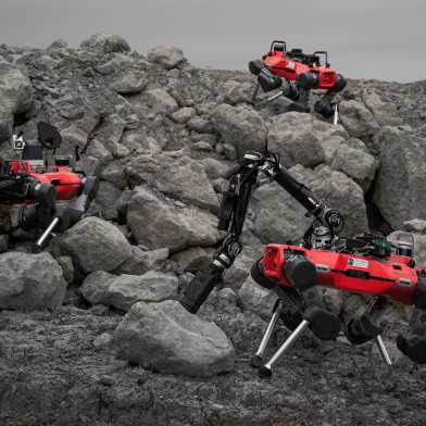 Three legged robots (red) in a stony landscape (gravel quarry).