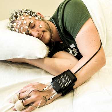 Man with measuring mask on head sleeping