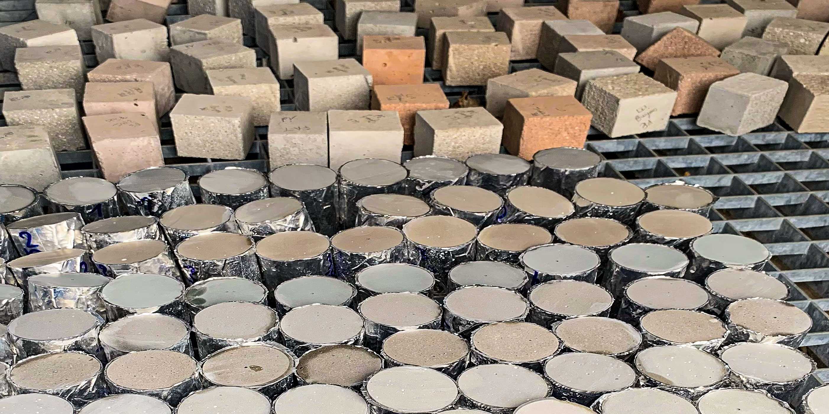 Concrete cubes and cylinders stacked next to each other
