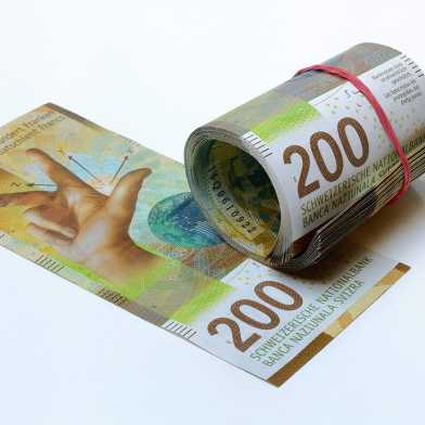 Rolled-in banknotes next to a 200 note.