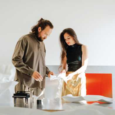 A man and a woman inspecting material 