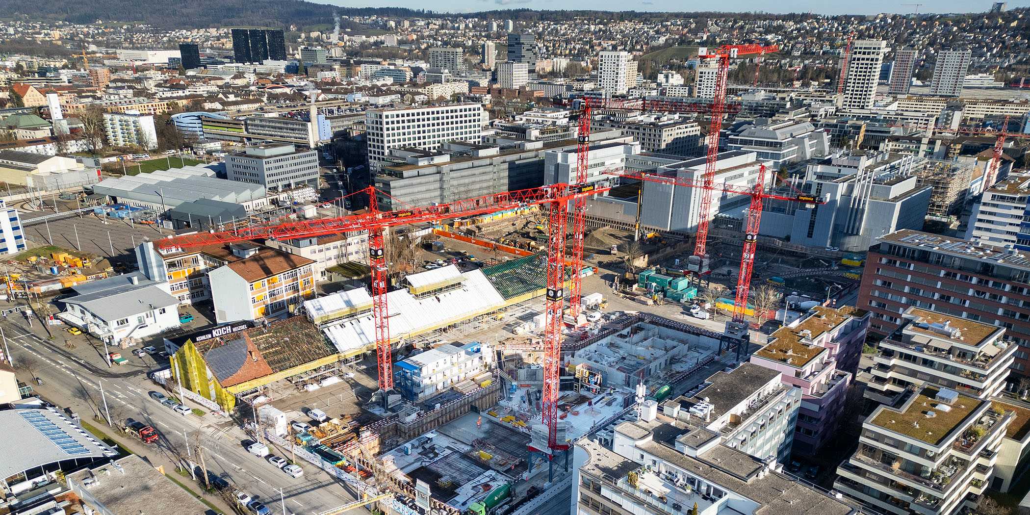 Koch site in Zurich-Altstetten from the air, showing construction site with cranes.