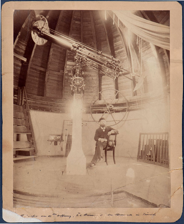 Enlarged view: Historical photograph taken of Alfred Wolfer with the Kern-Merz refractor in the dome of the Semper Observatory.