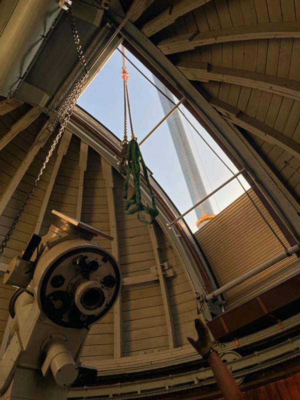 Enlarged view: Photo shows the refractor in the dome while the crane is approaching from outside.